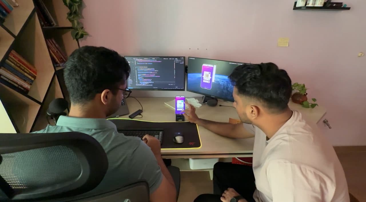 Two Beyond Softwares developers testing a mobile app on a real device